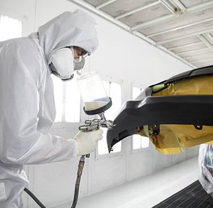 Collision Center Technician Painting a Vehicle | Jim Shorkey Toyota of Greensburg in Greensburg PA