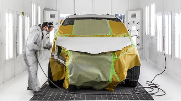 Collision Center Technician Painting a Vehicle | Jim Shorkey Toyota of Greensburg in Greensburg PA